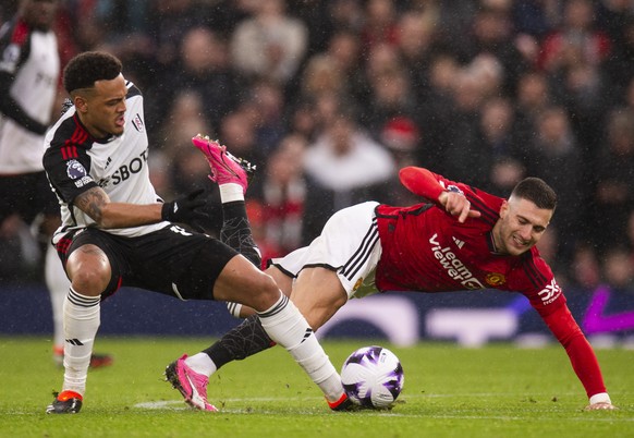 epa11178579 Rodrigo Muniz of Fulham in action with Diogo Dalot of Manchester United during the English Premier League match between Manchester United and Fulham FC, in Manchester, Britain, 24 February ...