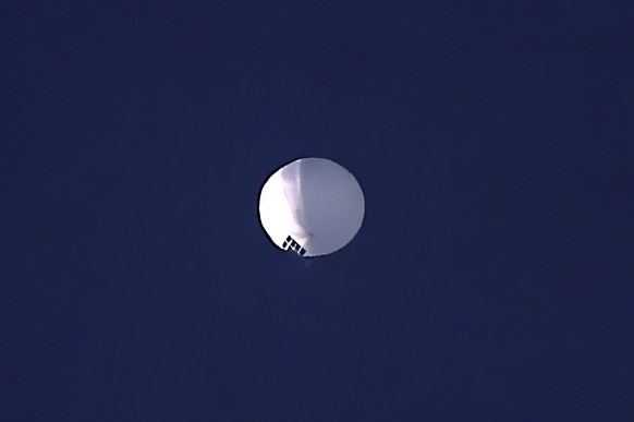 FILE - A high altitude balloon floats over Billings, Mont., Feb. 1, 2023. Just 40% of U.S. adults approve of how President Joe Biden is handling relations with China, a new poll shows, with a majority ...