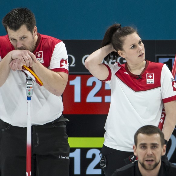 Martin Rios of Switzerland, Jenny Perret of Switzerland, and Aleksandr Krushelnitckii of the Olympic Athlete from Russia, from left, during the Mixed Doubles Curling semi final game between Switzerlan ...