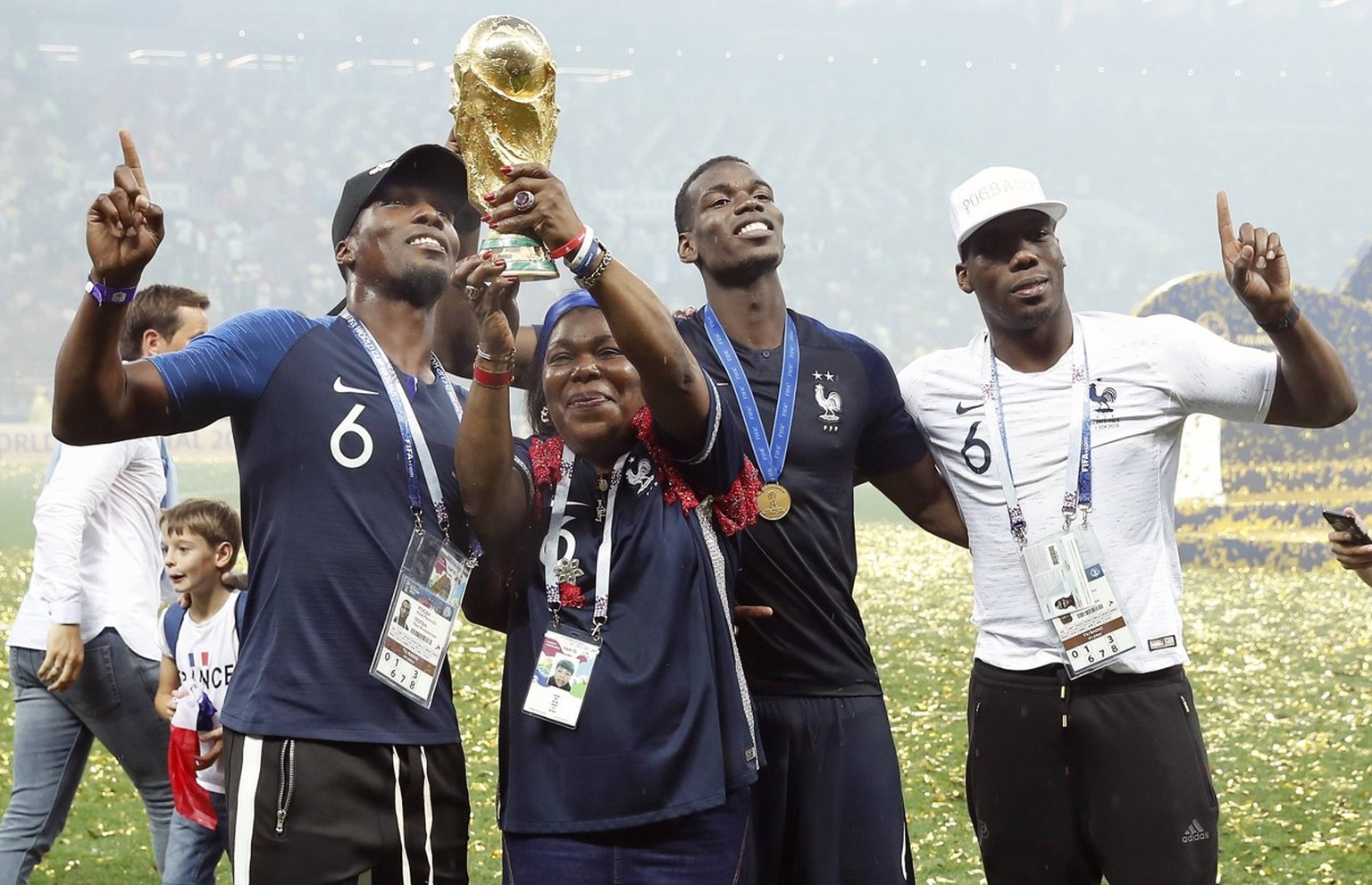 Paul Pogba of France and his brothers Florentin, Mathias, and his mother Yeo Pogba with the world cup trophy, FIFA World Cup WM Weltmeisterschaft Fussball during the 2018 FIFA World Cup Russia Final m ...