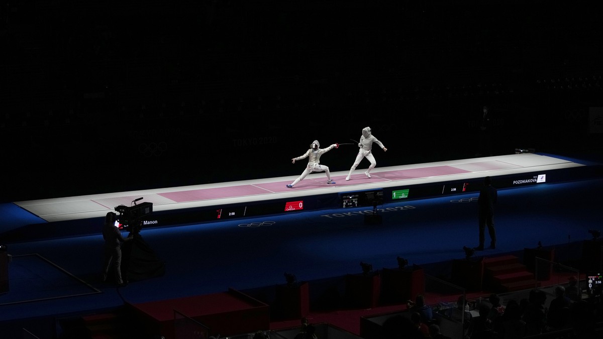 Sofia Pozdniakova of the Russian Olympic Committee, right, and Manon Brunet of France compete in the women's individual semifinal Sabre competition at the 2020 Summer Olympics, Monday, July 26, 2 ...