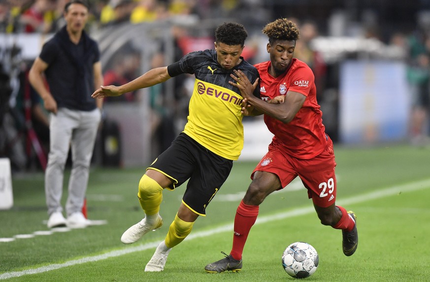 Bayern's Kingsley Coman, right, duels for the ball with Dortmund's Jadon Sancho during the German Supercup final soccer match between Borussia Dortmund and Bayern Munich in Dortmund, Germany ...