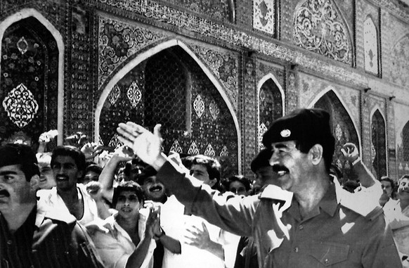 FILE - In this Aug. 9, 1988 file photo, Iraqi President Saddam Hussein waves to cheering crowds during a visit to the holy muslim shrines in Samara. The Iraqi President visited the site for prayers an ...