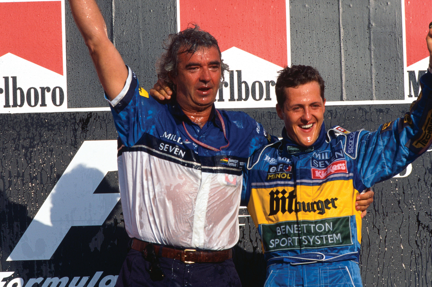 Tanaka International, Aida, Japan. 20-22 October 1995. Michael Schumacher (Benetton B195 Renault), 1st position with team boss Flavio Briatore, celebrate taking his second successive drivers World Cha ...