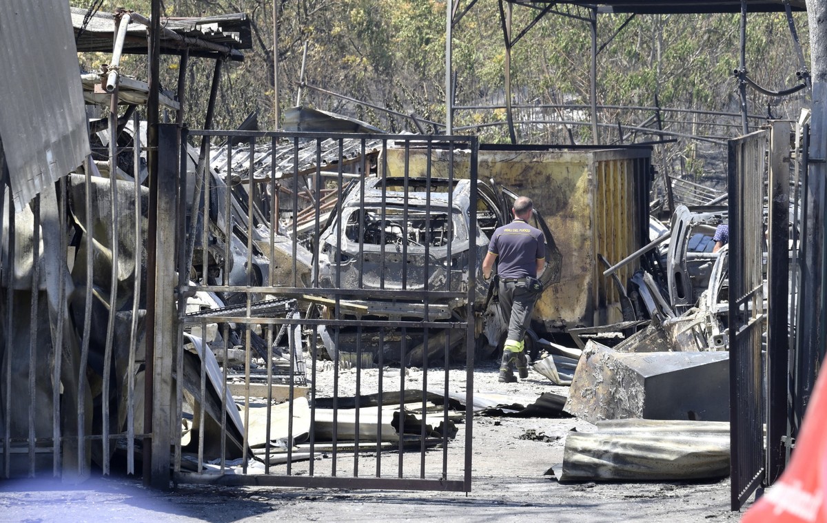epa10063565 Aftermath of a vast fire that broke out on 09 July in Palmiro Togliatti avenue, in Rome, Italy, 10 July 2022. Firefighters are still working to extinguish the fire although it is under con ...