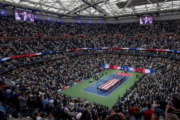 epaselect epa12361280 US President Donald J. Trump is displayed on overhead televisions during prematch ceremonies before Carlos Alcaraz of Spain faces Jannik Sinner of Italy during the men's sin ...