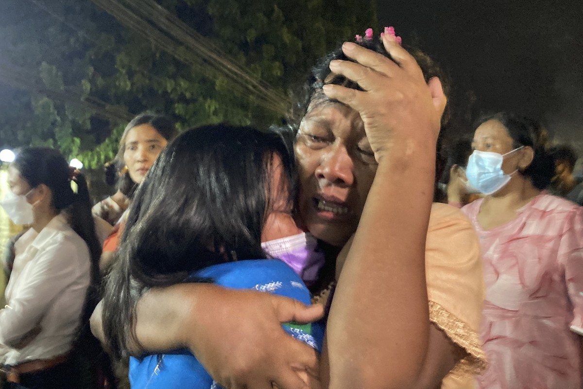 A mother reacts after her daughter, left, was released from Insein Prison in Yangon, Myanmar, Monday, Oct. 18, 2021. Myanmar's government on Monday announced an amnesty for more than 5,600 people ...
