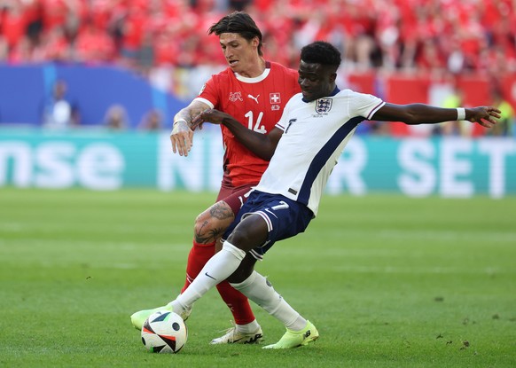 epa11463227 Steven Zuber of Switzerland (L) and Bukayo Saka of England (R) in action during the UEFA EURO 2024 quarter-finals soccer match between England and Switzerland, in Dusseldorf, Germany, 06 J ...