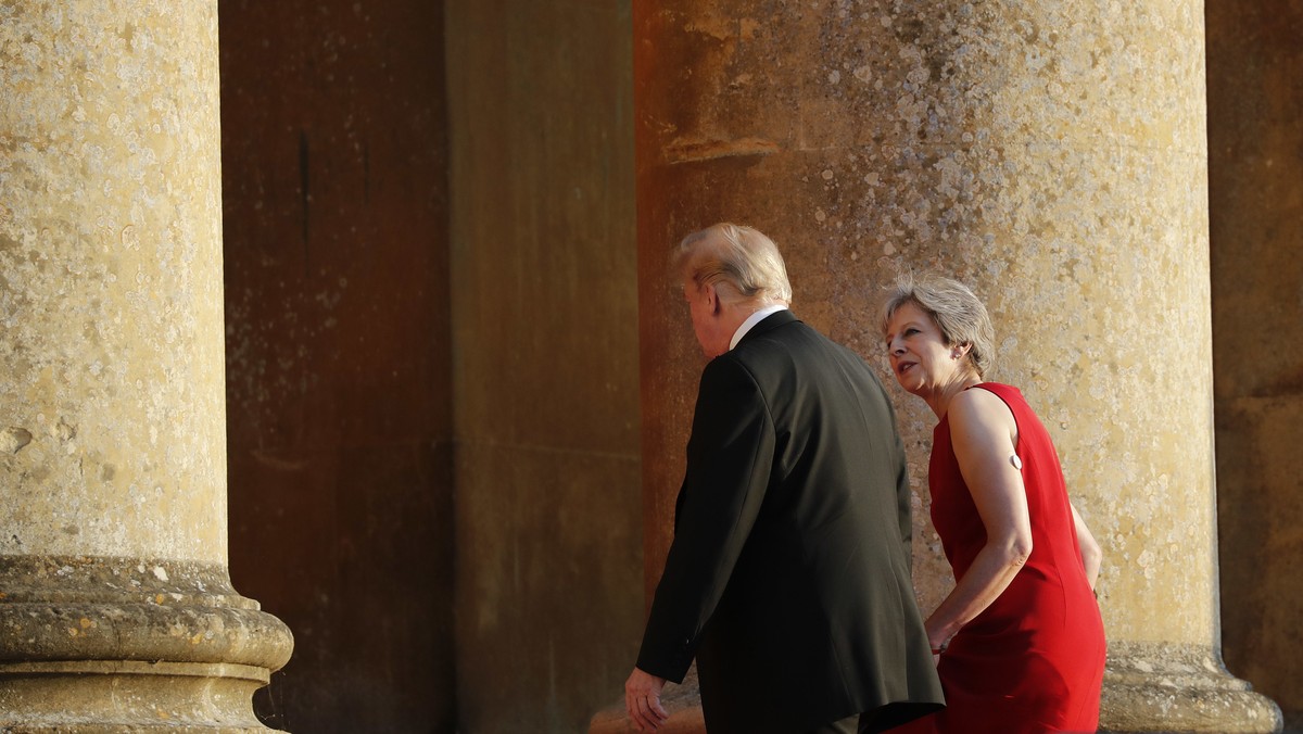 British Prime Minister Theresa May, right, talks with President Donald Trump, left, as they walk into Blenheim Palace, Oxfordshire, where May will host a dinner as part of Trump's visit to the Un ...