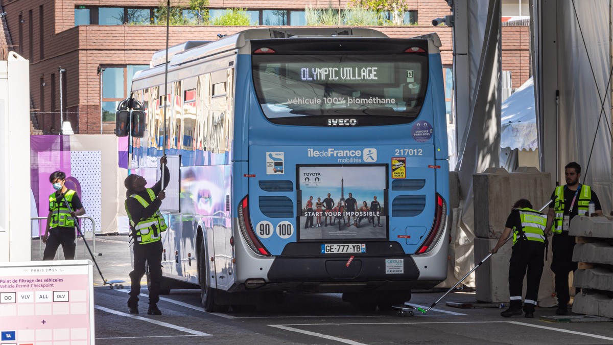 epa11485519 A bus passes by the security checks at the entrance of the Athletes' Village of the Paris 2024 Olympic Games in Saint Denis, France, 18 July 2024. The Summer Olympics are scheduled to ...