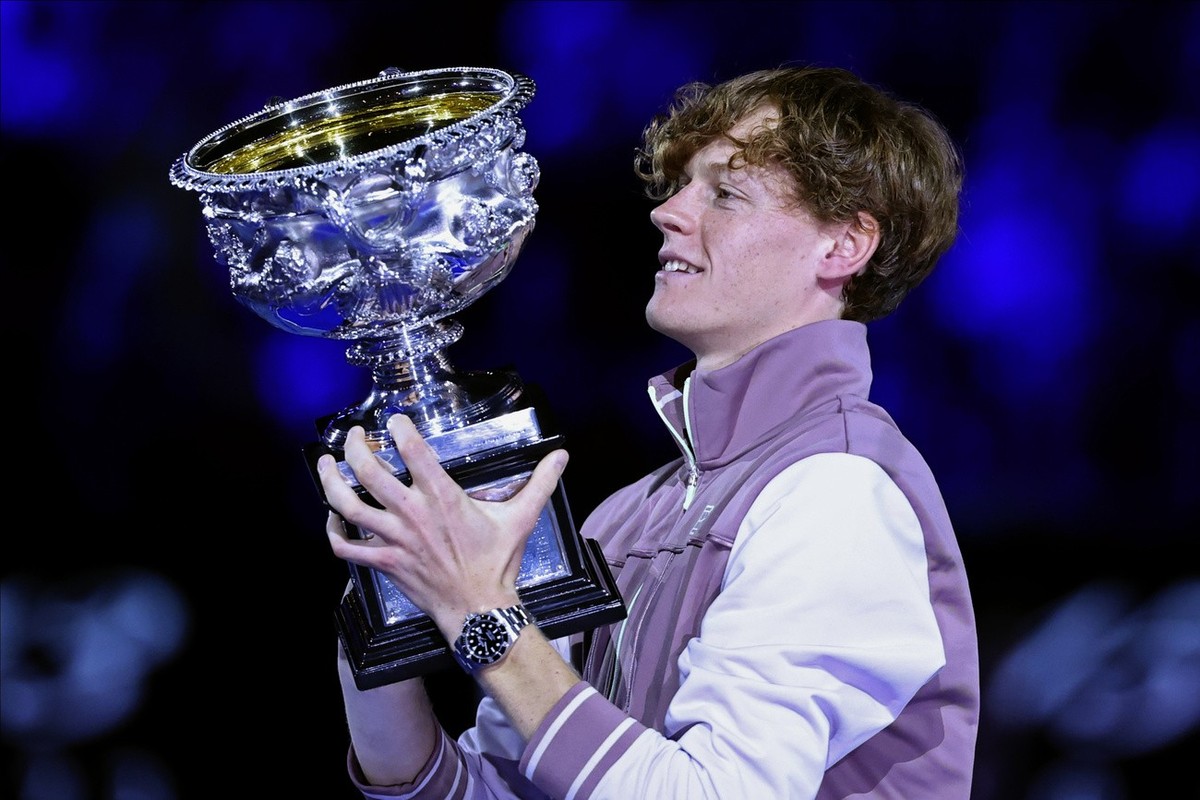 Jannik Sinner of Italy holds the Norman Brookes Challenge Cup aloft after defeating Daniil Medvedev of Russia in the men's singles final at the Australian Open tennis championships at Melbourne P ...