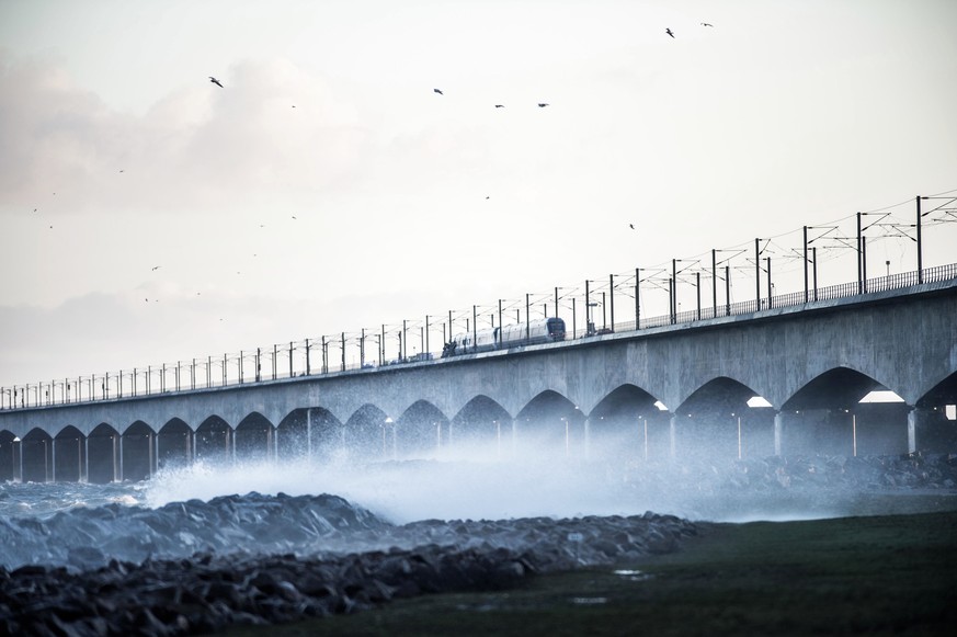 epa07257997 A damaged freight train stands at the Great Belt Bridge in Nyborg, Denmark, 02 January 2019, after a train accident. Trail transport operator DSB announced that six people have died in the ...