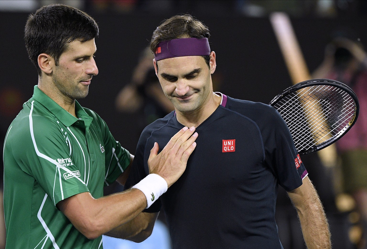 Switzerland&#039;s Roger Federer, right, congratulates Serbia&#039;s Novak Djokovic on winning their semifinal match at the Australian Open tennis championship in Melbourne, Australia, Thursday, Jan.  ...