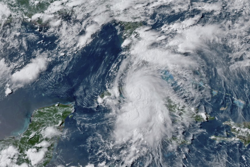This GOES-16 GeoColor satellite image taken Monday, July 5, 2021, at 4:50 p.m. EDT, and provided by NOAA, shows Tropical Storm Elsa over western Cuba with strong rain and winds. Forecasters say it wil ...