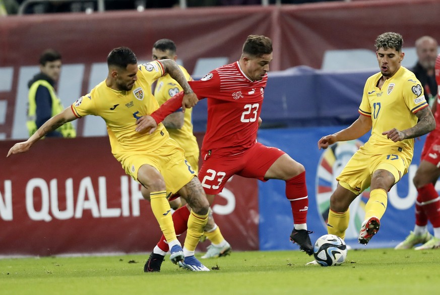 epa10988307 Romania&#039;s Vladimir Screciu (L) and Romania&#039;s Adrian Rus (R) in action against Switzerland&#039;s Xherdan Shaqiri (C) during the UEFA EURO 2024 Group I qualification match between ...