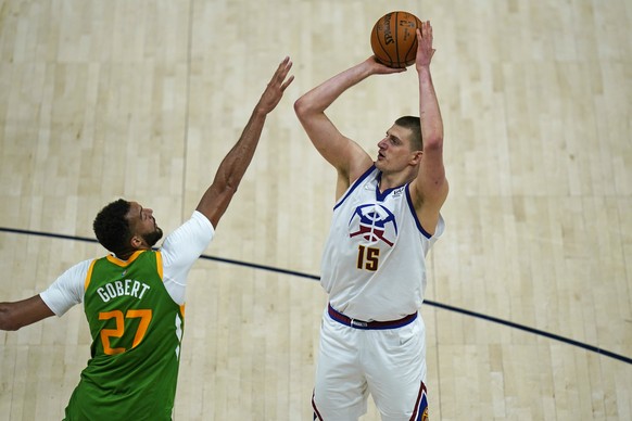 Denver Nuggets center Nikola Jokic (15) shoots as Utah Jazz center Rudy Gobert (27) defends during the second half of an NBA basketball game Friday, May 7, 2021, in Salt Lake City. (AP Photo/Rick Bowm ...