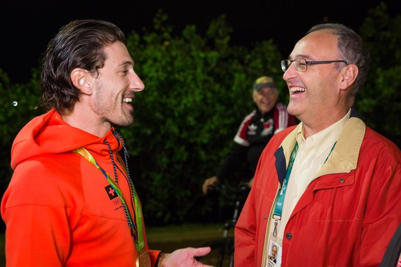 HANDOUT - Gold medal winner Fabian Cancellara of Switzerland, left, and Swiss Sport Minister Guy Parmelin, right, shake hands in the House of Switzerland at the Rio 2016 Summer Olympics in Rio de Jane ...