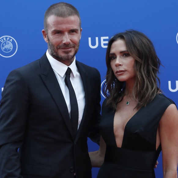 epa06984431 British former soccer player David Beckham (L) and his wife, British fashion designer Victoria Beckham arrive for the UEFA Champions League Group Stage Draw and Awards in Monaco, 30 August ...