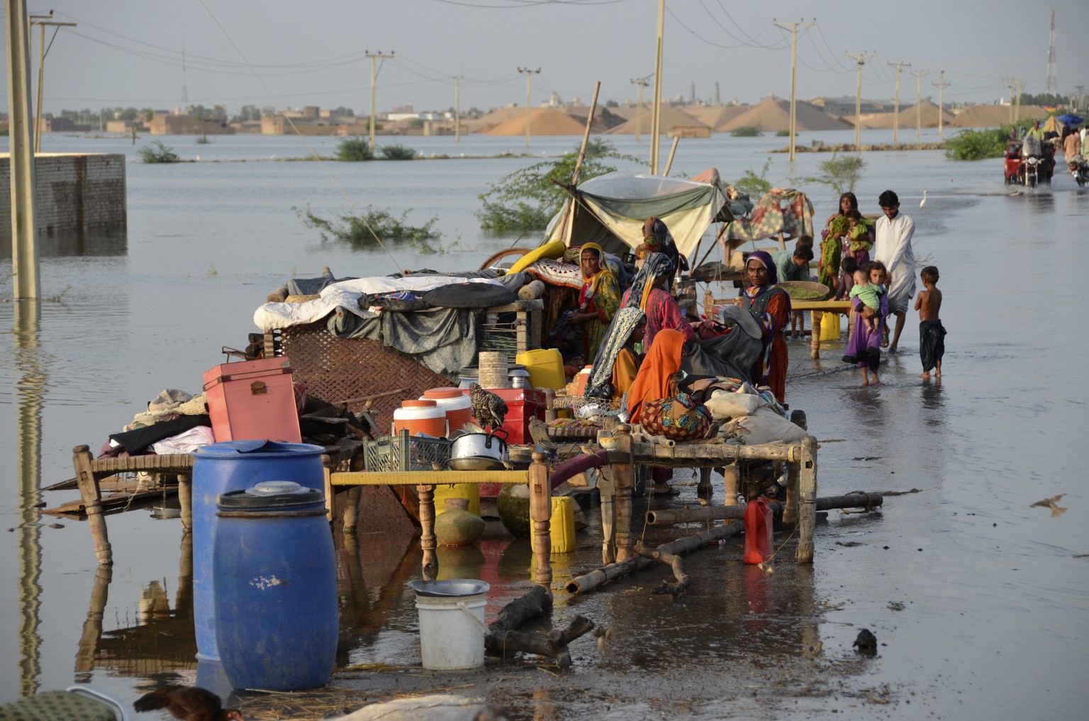 Families sit near their belongings surrounded by floodwaters, in Sohbat Pur city of Jaffarabad, a district of Pakistan&#039;s southwestern Baluchistan province, Sunday, Aug. 28, 2022. Officials in Pak ...