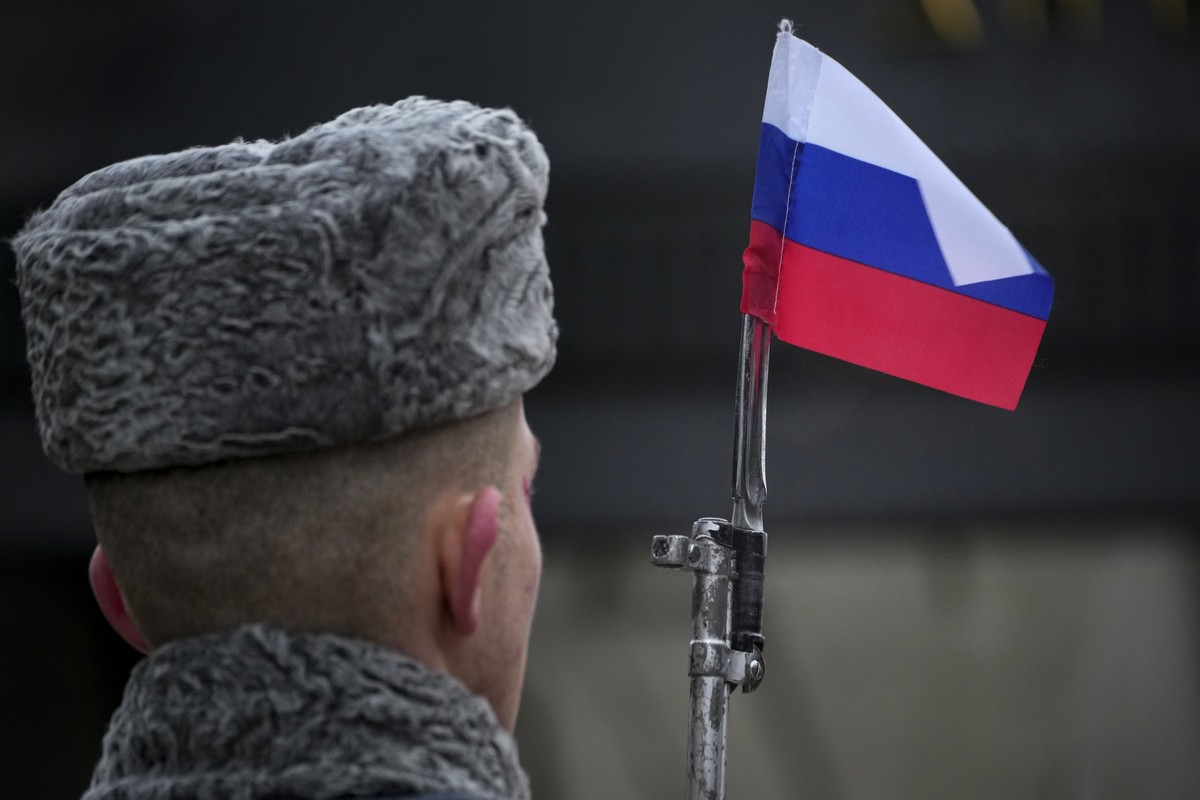 A honour guard soldier holds a rifle with a Russian flag mounted on a gun's bayonet during a commemoration ceremony at the monument of the Heroic Defenders of Leningrad, in St. Petersburg, Russia ...