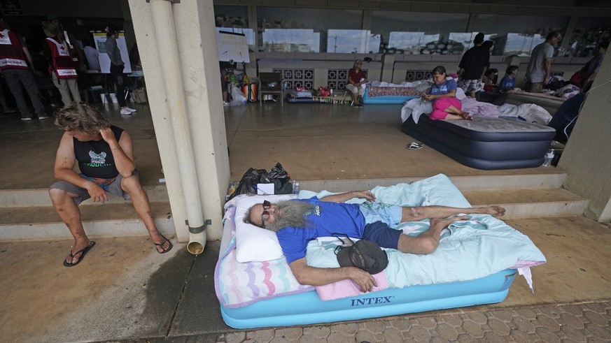 Thomas Leonard lies on an air mattress at an evacuation center at the War Memorial Gymnasium after his Lahaina apartment was destroyed by wildfire, Thursday, Aug. 10, 2023, in Wailuku, Hawaii. (AP Pho ...