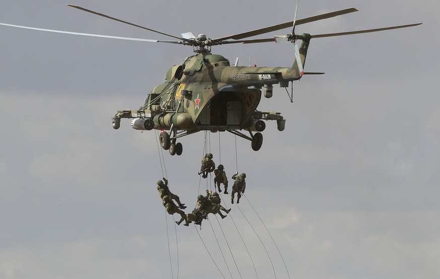 FILE - Soldiers abseil from a military helicopter over the training ground during strategic command and staff exercises Center-2019 at Donguz shooting range near Orenburg, Russia, Sept. 20, 2019. The  ...