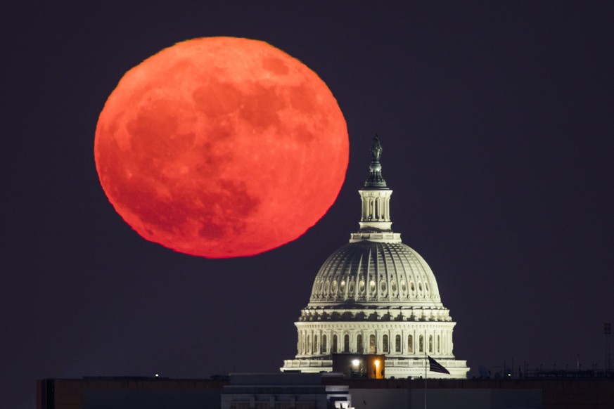 epa06365864 A so-called &#039;supermoon&#039; rises behind the US Capitol in Washington, DC, viewed from Arlington, Virginia, USA, 03 December 2017. A supermoon occurs when a full moon coincides with  ...