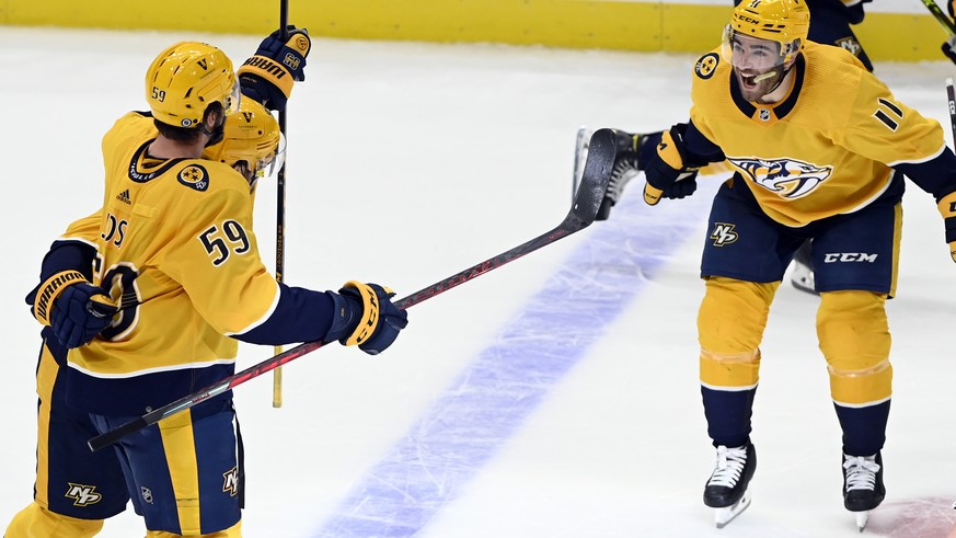 Nashville Predators center Matt Duchene, left, celebrates with defenseman Roman Josi (59) and center Luke Kunin (11) after Duchene scored the winning goal against the Colorado Avalanche during overtim ...