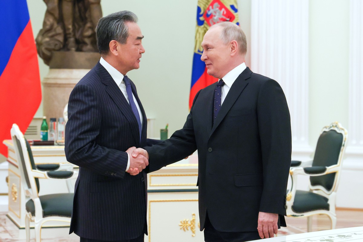 Russian President Vladimir Putin greets Chinese Communist Party's foreign policy chief Wang Yi during their meeting at the Kremlin in Moscow, Russia, Wednesday, Feb. 22, 2023. (Anton Novoderezhki ...