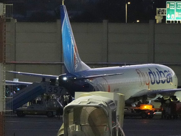 People disembark from a FlyDubai carrying Israeli passengers who had earlier been aboard another FlyDubai aircraft that made an emergency landing in Saudi Arabia approaches Ben Gurion International Ai ...