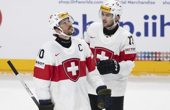Switzerland&#039;s Roman Josi, left, and Nico Hischier react during the Ice Hockey World Championship group A preliminary round match between Switzerland and Denmark in Prague at the O2 Arena, Czech R ...