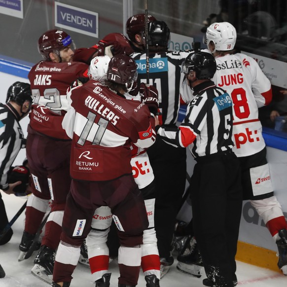 epa12052495 Players of Switzerland and Latvia clash during the friendly international ice hockey match between Latvia and Switzerland in Riga, Latvia, 24 April 2025. EPA/TOMS KALNINS