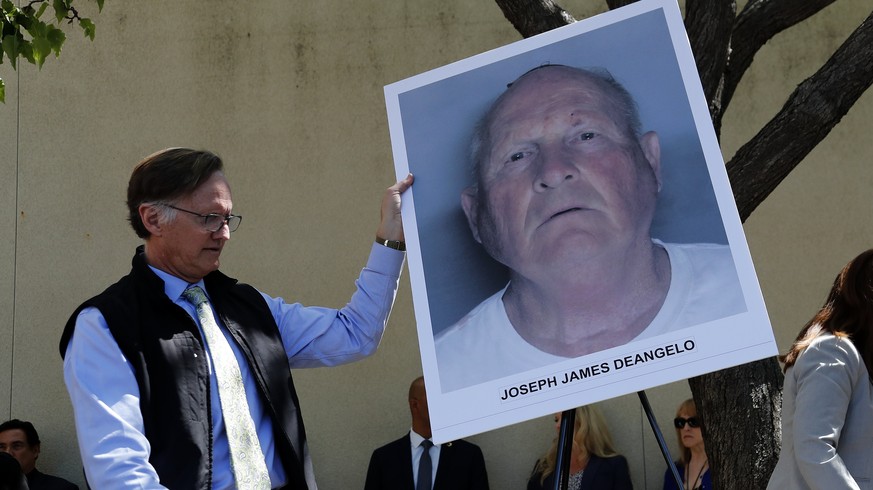 epa06693047 An official puts a mug shot on an easel stand, of the suspect identified as Joseph James DeAngelo, 72, a former police officer in Visalia and Auburn, California before a press conference a ...