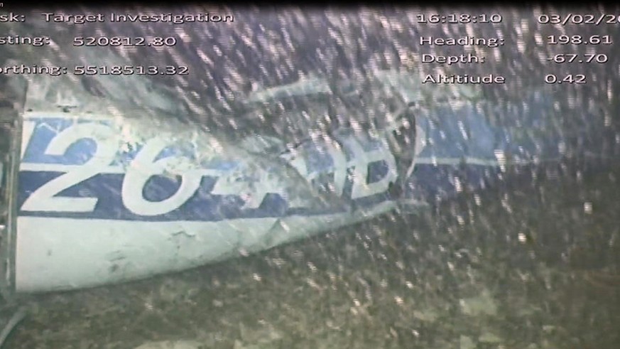 In this image released Monday Feb. 4, 2019, by the UK Air Accidents Investigation Branch (AAIB) showing the rear left side of the fuselage including part of the aircraft registration N264DB that went  ...