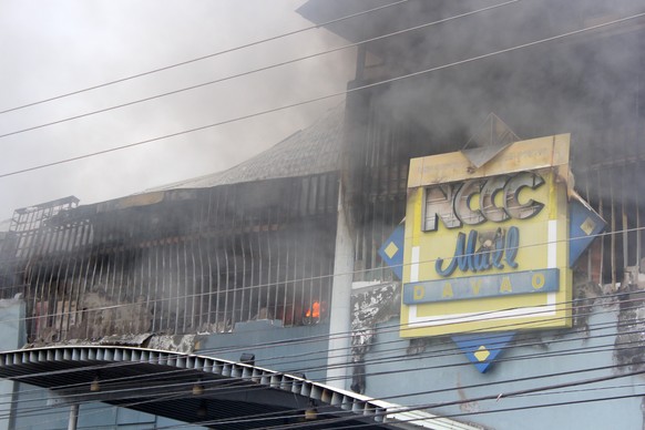epa06404430 A view of a burning shopping mall in Davao city, southern Philippines, 23 December 2017 (issued 24 December 2017). According to news reports, at least 37 people were feared dead in a fire  ...