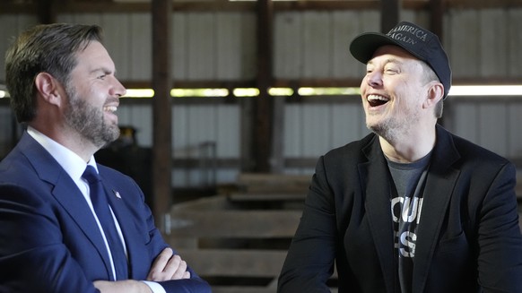 Tesla and SpaceX CEO Elon Musk, right, and Republican vice presidential nominee Sen. JD Vance, R-Ohio, attend a campaign event with Republican presidential nominee former President Donald Trump at the ...