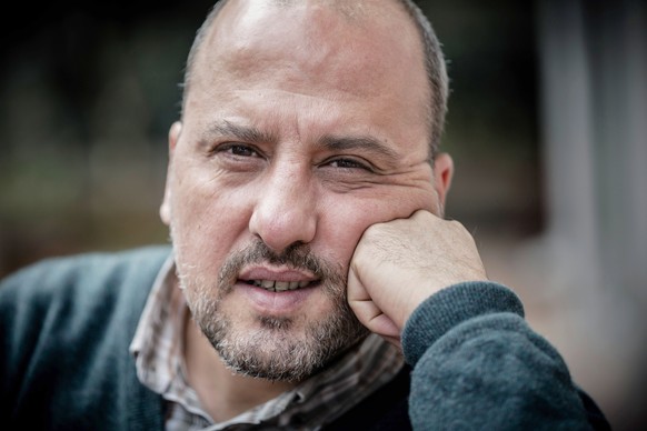 FILE - Dec. 18, 2014 file photo of journalist Ahmet Sik, an investigative journalist of opposition newspaper Cumhuriyet, poses for a photos in Istanbul. Journalists and staff from a Turkish newspaper  ...