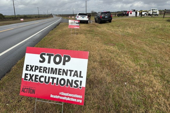 Anti-death penalty activists place signs along the road heading to Holman Correctional Facility in Atmore, Ala., ahead of the scheduled execution of Kenneth Eugene Smith on Thursday, Jan. 25, 2024. Th ...