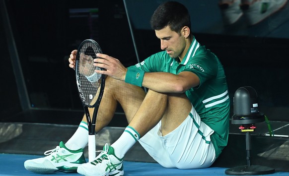 epa09015886 Novak Djokovic of Serbia reacts during his Men&#039;s Quarter finals singles match against Alexander Zverev of Germany on Day 9 of the Australian Open at Melbourne Park in Melbourne, Austr ...