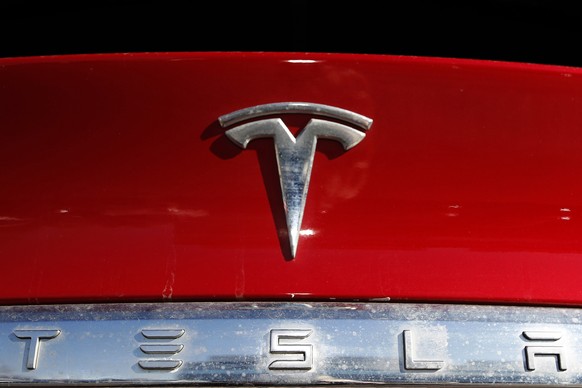 FILE - The Tesla company logo sits on an unsold 2020 Model X at a Tesla dealership in Littleton, Colo., Feb. 2, 2020. .The National Highway Traffic Safety Administration said Friday, April 7, 2023, th ...