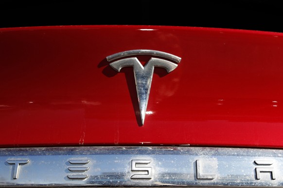 FILE – Tesla's corporate logo appears on an unsold 2020 Model X at a Tesla dealership in Littleton, Colo. Feb. 2, 2020. The National Highway Traffic Safety Administration said on Friday, April 7, 2023, that the…
