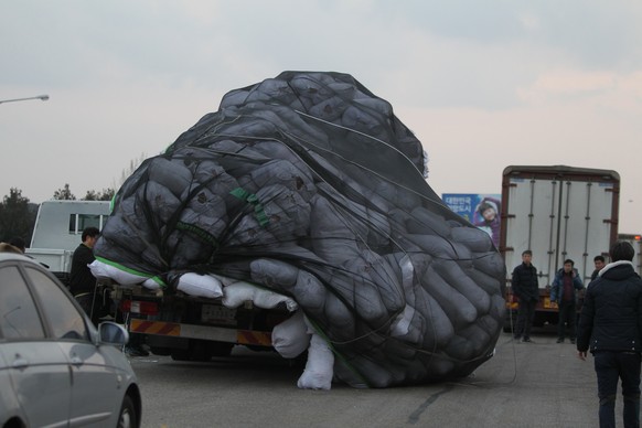 Products fall from an overloaded vehicle after returning from North Korea&#039;s Kaesong industrial complex in Paju, South Korea, Thursday, Feb. 11, 2016. North Korea on Thursday vowed to immediately  ...