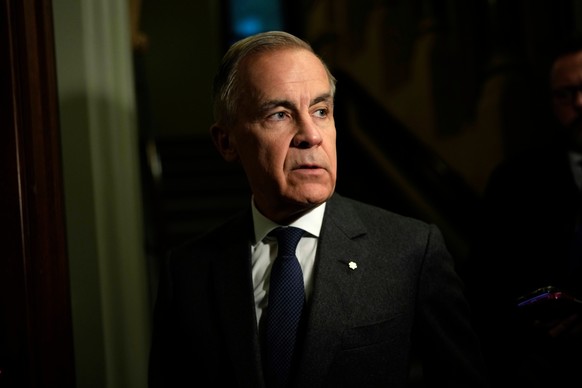 Prime Minister Mark Carney takes questions from journalists as he makes his way to a meeting of the Liberal caucus on Parliament Hill in Ottawa, on Wednesday, Feb. 25, 2026.(Justin Tang /The Canadian  ...