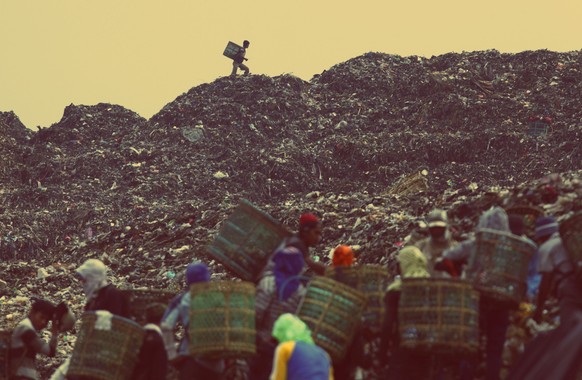 Eine Gruppe Menschen sammelt auf der Hauptmülldeponie in Bekasi Plastik, um es recyclen zu können.