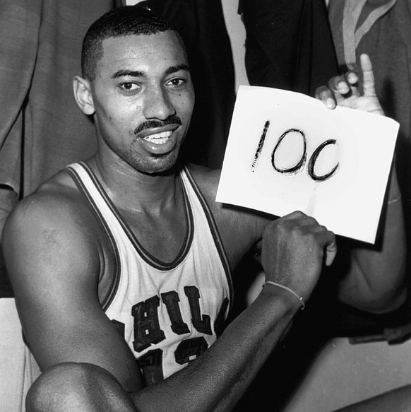 FILE -- Wilt Chamberlain of the Philadelphia Warriors holds a sign reading &quot;100&quot; in the dressing room in Hershey, Pa., after he scored 100 points as the Warriors defeated the New York Knicke ...