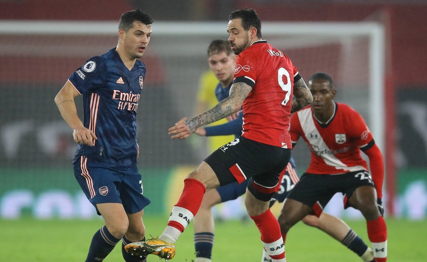 Granit Xhaka of Arsenal guides the ball past Danny Ings of Southampton during the Premier League match at St Mary s Stadium, Southampton. Picture date: 26th January 2021. Picture credit should read: D ...