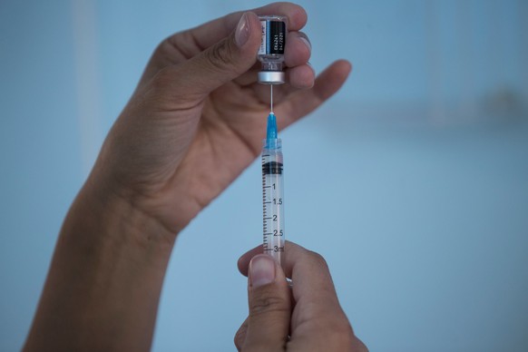 epa08903084 A nurse prepares a vaccine against COVID-19 in Santiago, Chile, 24 December 2020. Chile became the second country in Latin America to start the vaccination process against COVID-19 after M ...