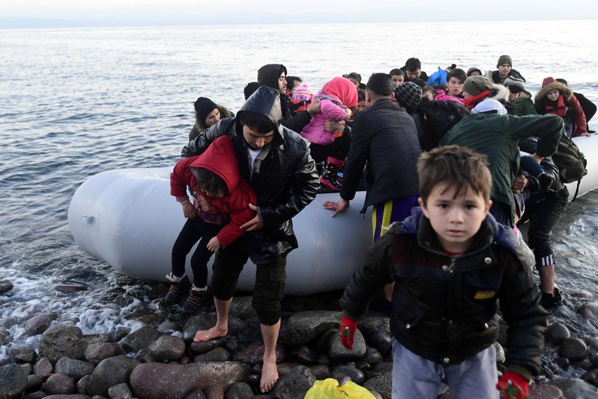 Migrants arrive at the village of Skala Sikaminias, on the Greek island of Lesbos, after crossing on a dinghy the Aegean sea from Turkey on Monday, March 2, 2020. Thousands of migrants and refugees ma ...