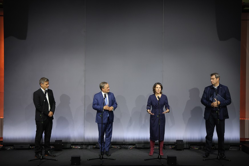 epa09507109 (L-R) Green party (Buendis90/Die Gruenen) co-chair Robert Habeck, Christian Democratic Union (CDU) party chairman Armin Laschet, Green party (Buendis90/Die Gruenen) co-chairwoman Annalena  ...
