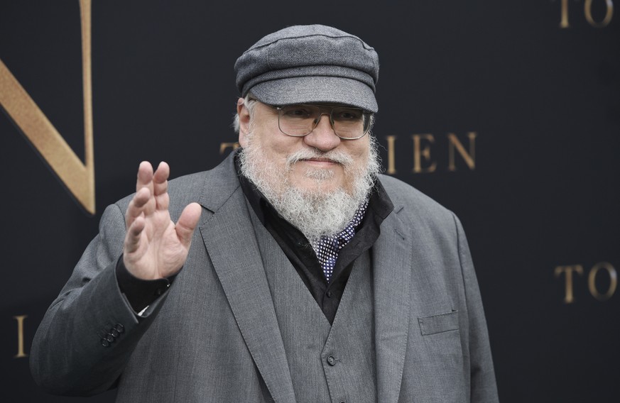 Author George R.R. Martin waves to photographers at the premiere of the film &quot;Tolkien,&quot; at the Regency Village Theatre, Wednesday, May 8, 2019, in Los Angeles. The film explores the formativ ...